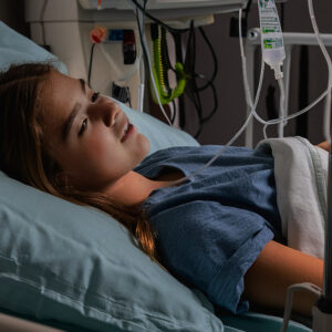Rachel Millward, teen daughter of Lauren and Brett Millward, very sick and in a hospital bed